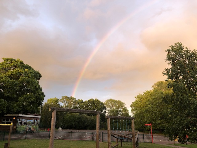 school playground with a rainbow in the sky